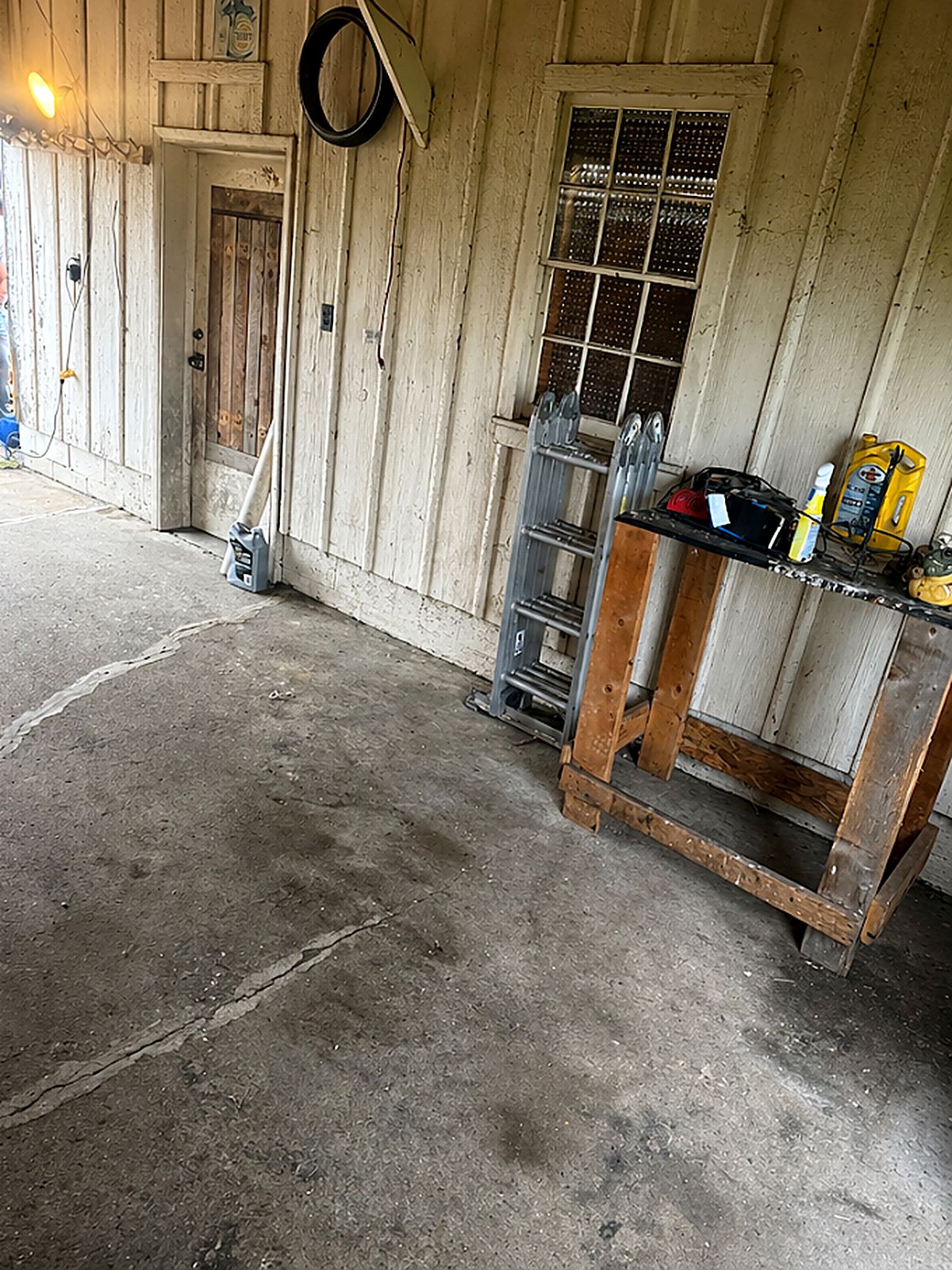 After: barn corner with overflowing bins and bags, cleared and swept